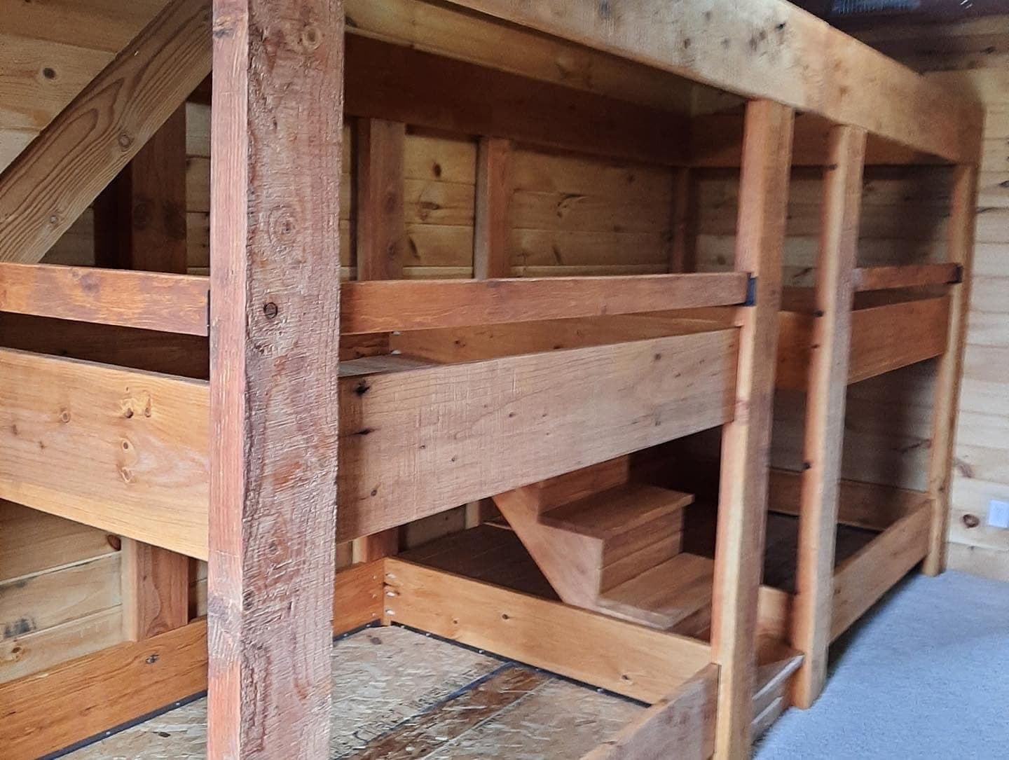 Timber-framed bunk beds built into a room
