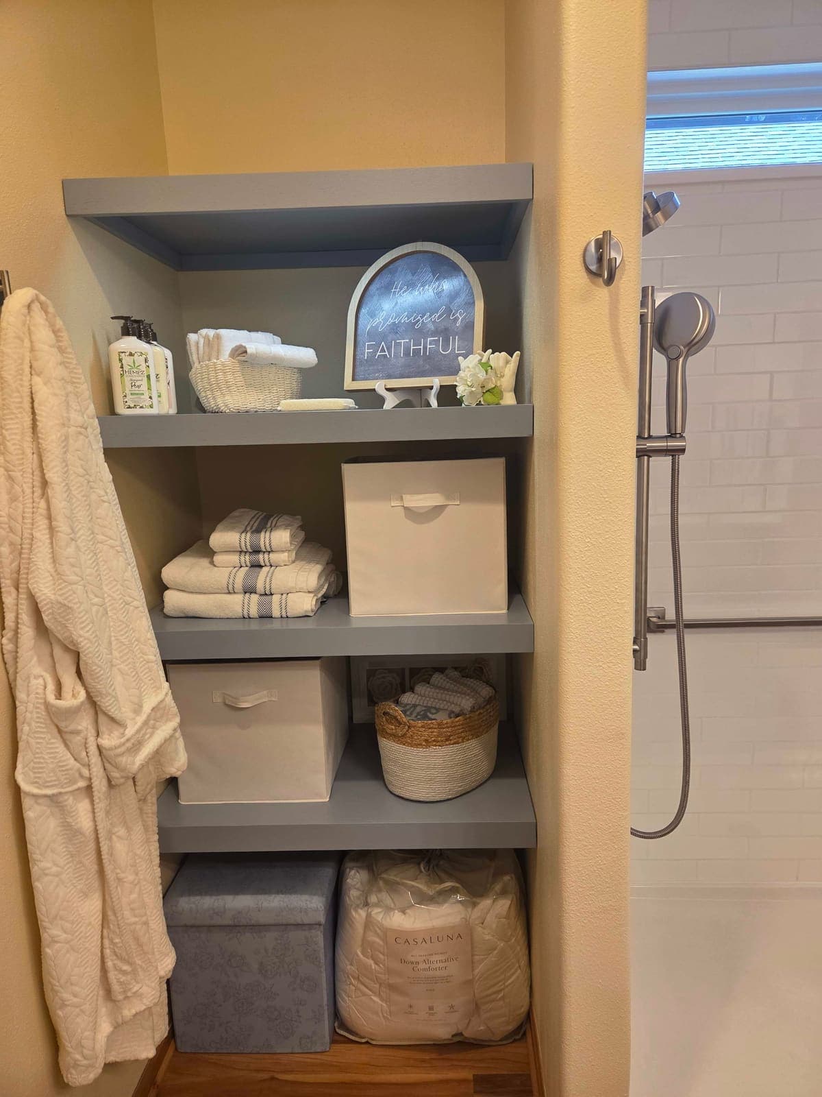 Painted built-in shelving fitted to a bathroom alcove.