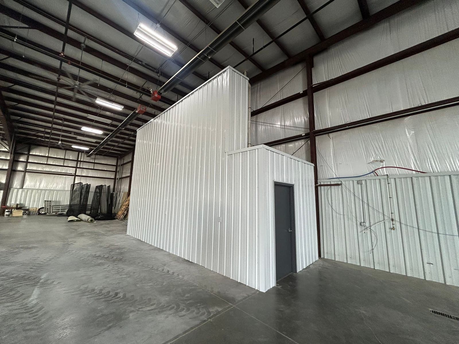 A room built inside a commercial shell, framed and clad in insulated panel.