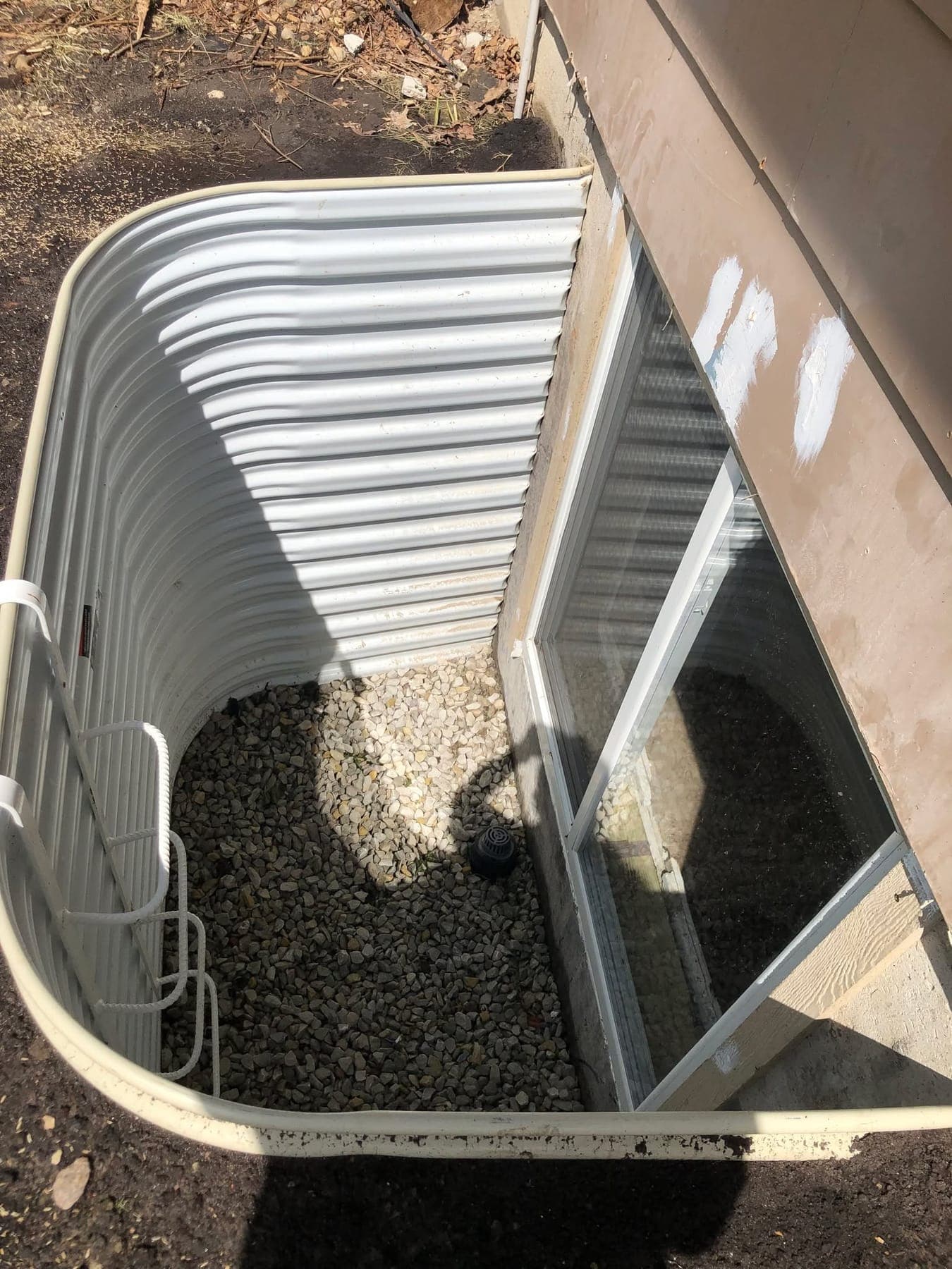 An egress window well fitted to a basement window