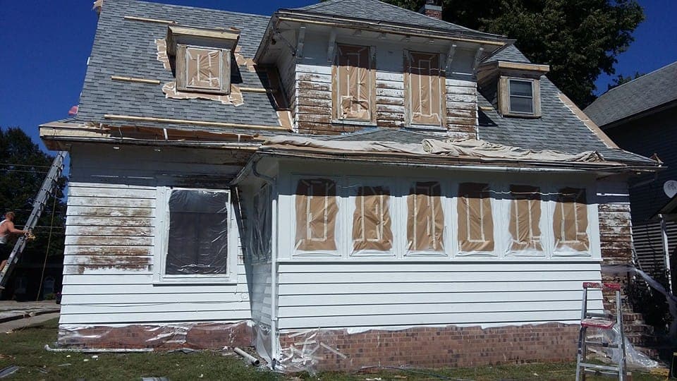 A house masked and prepared before any paint is applied