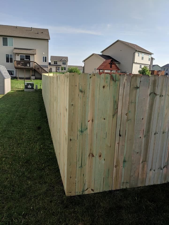 A new wood privacy fence along a boundary