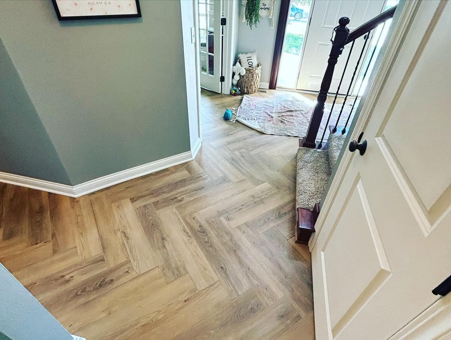 Herringbone plank flooring in an entry hall