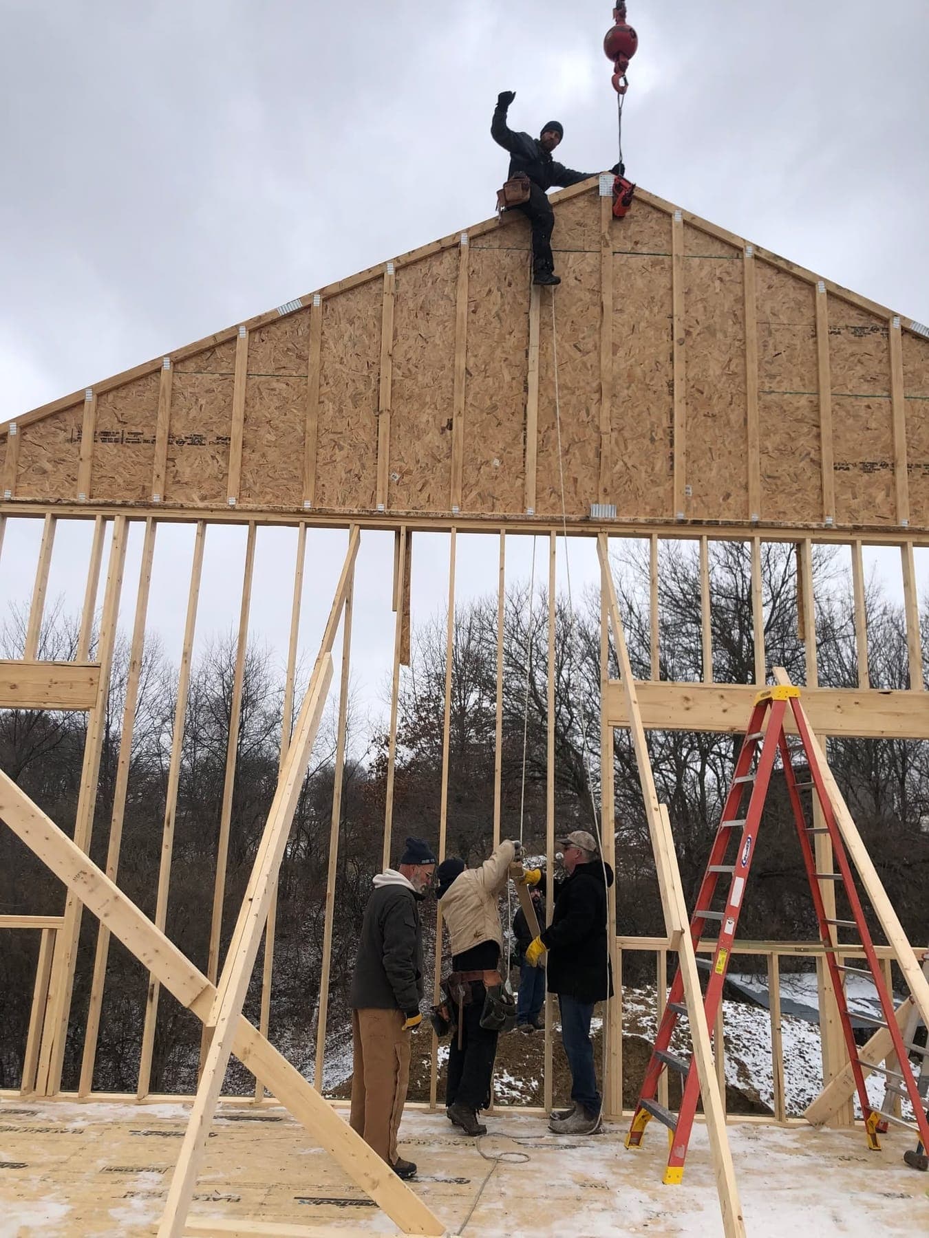 A gable wall being raised into place