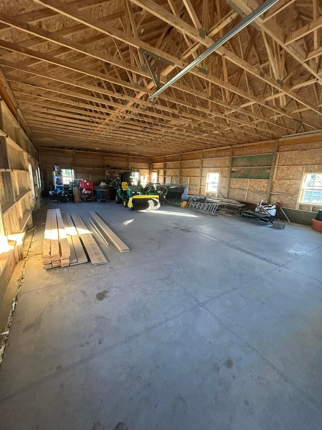 The inside of a post-frame building, showing the trusses