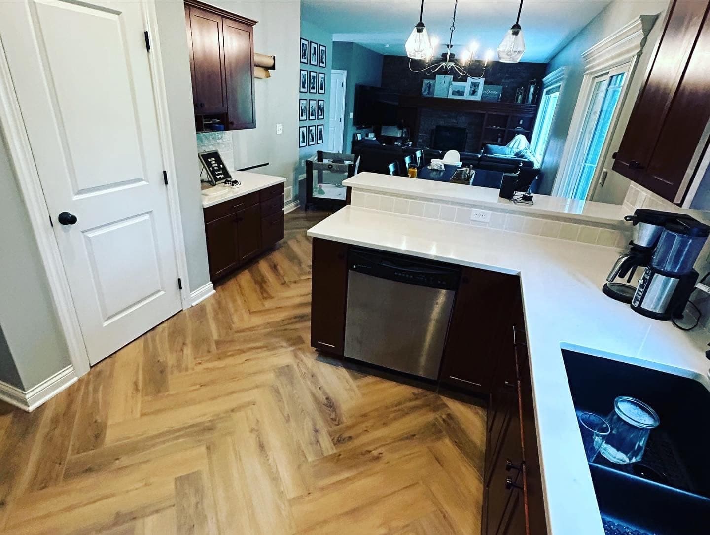 A kitchen with herringbone flooring running through it