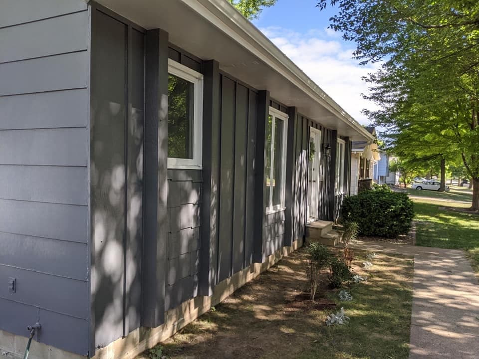 Dark board-and-batten siding on a ranch house