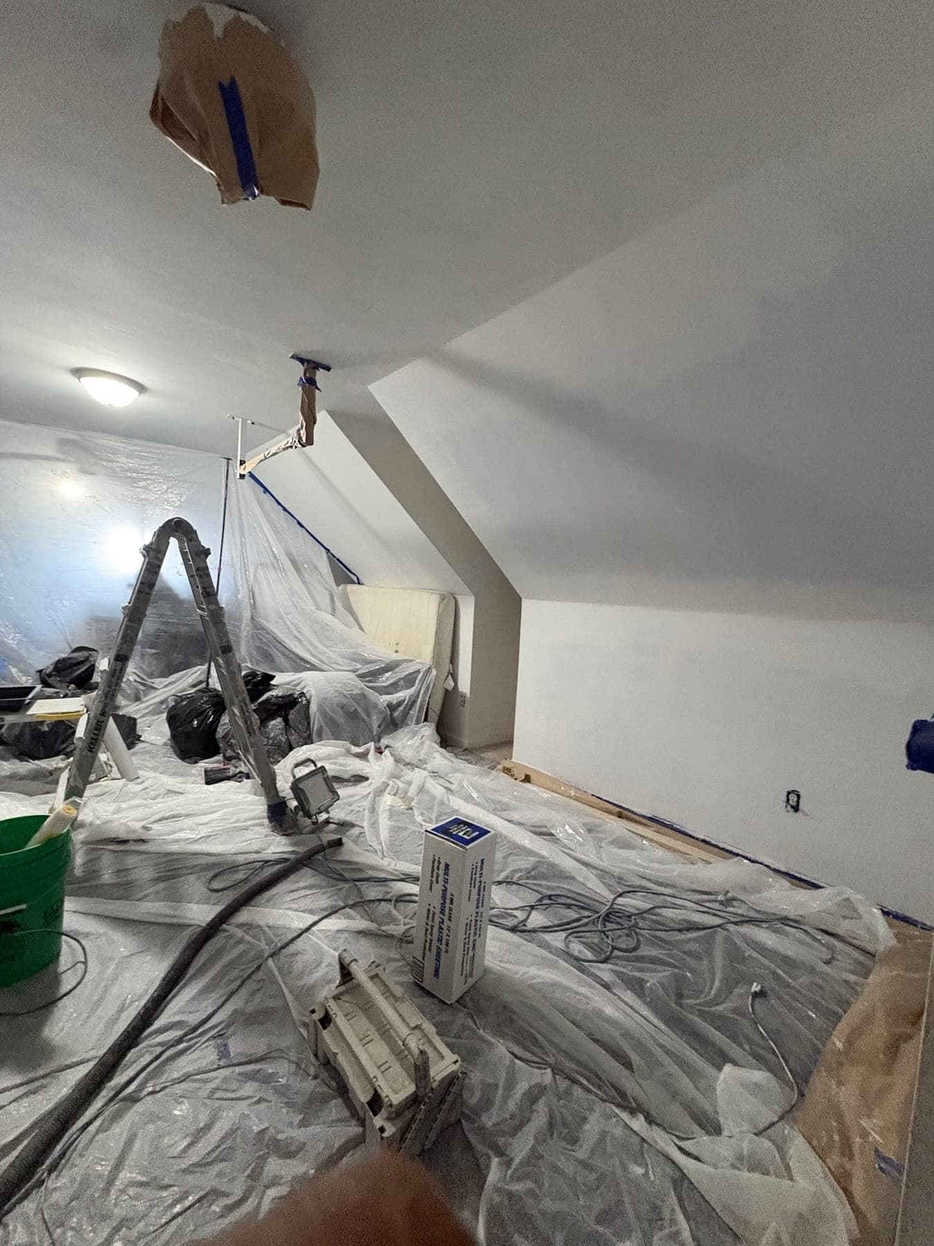 A room sheeted and masked before spraying