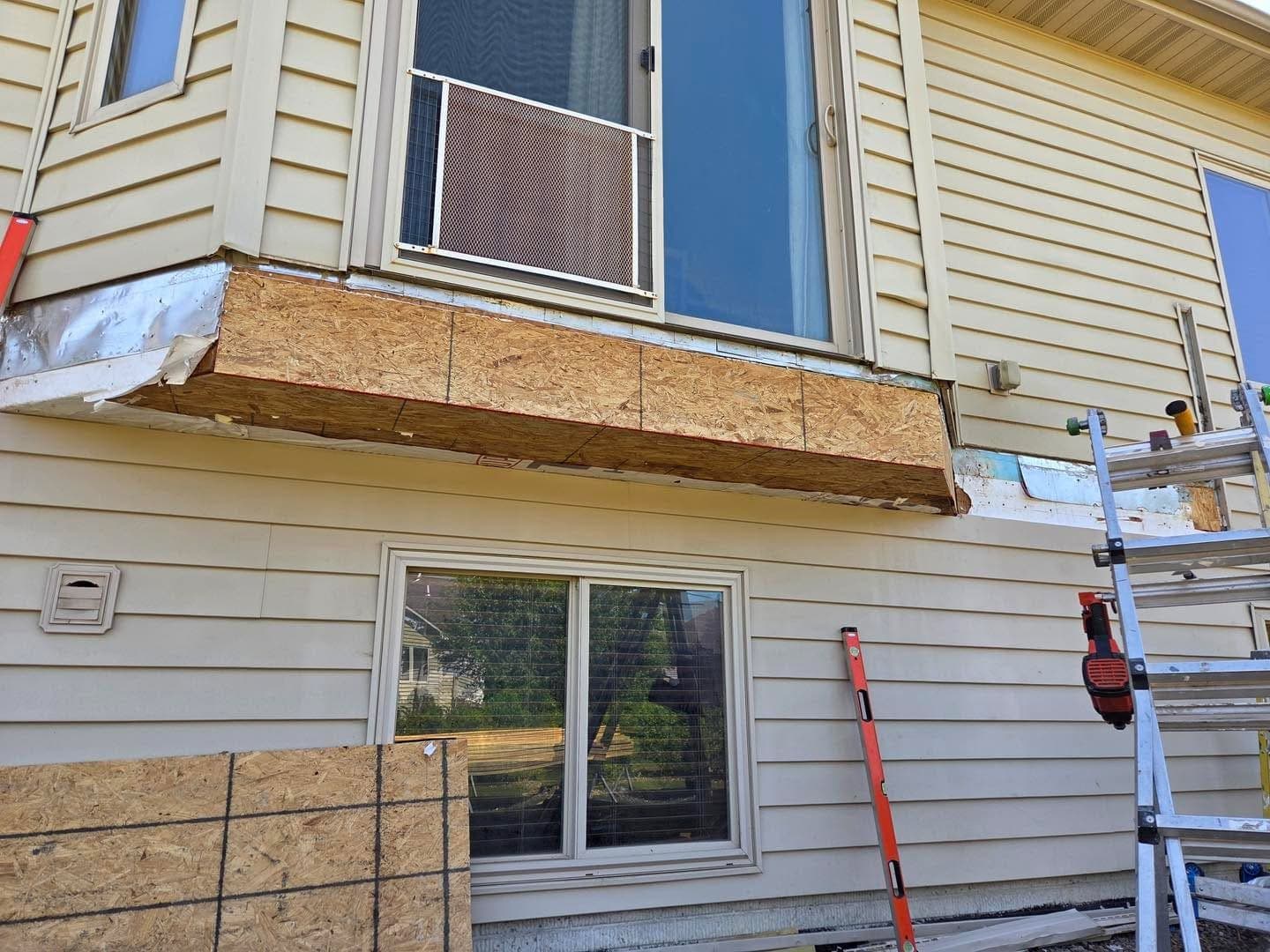 New sheathing let in where the rotted band was cut out, ready for the siding to go back on.