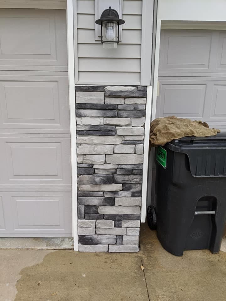 Stone veneer fitted between two garage doors